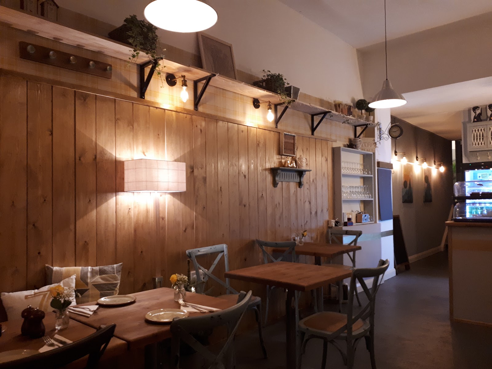 Timber-clad wall and warm lamps